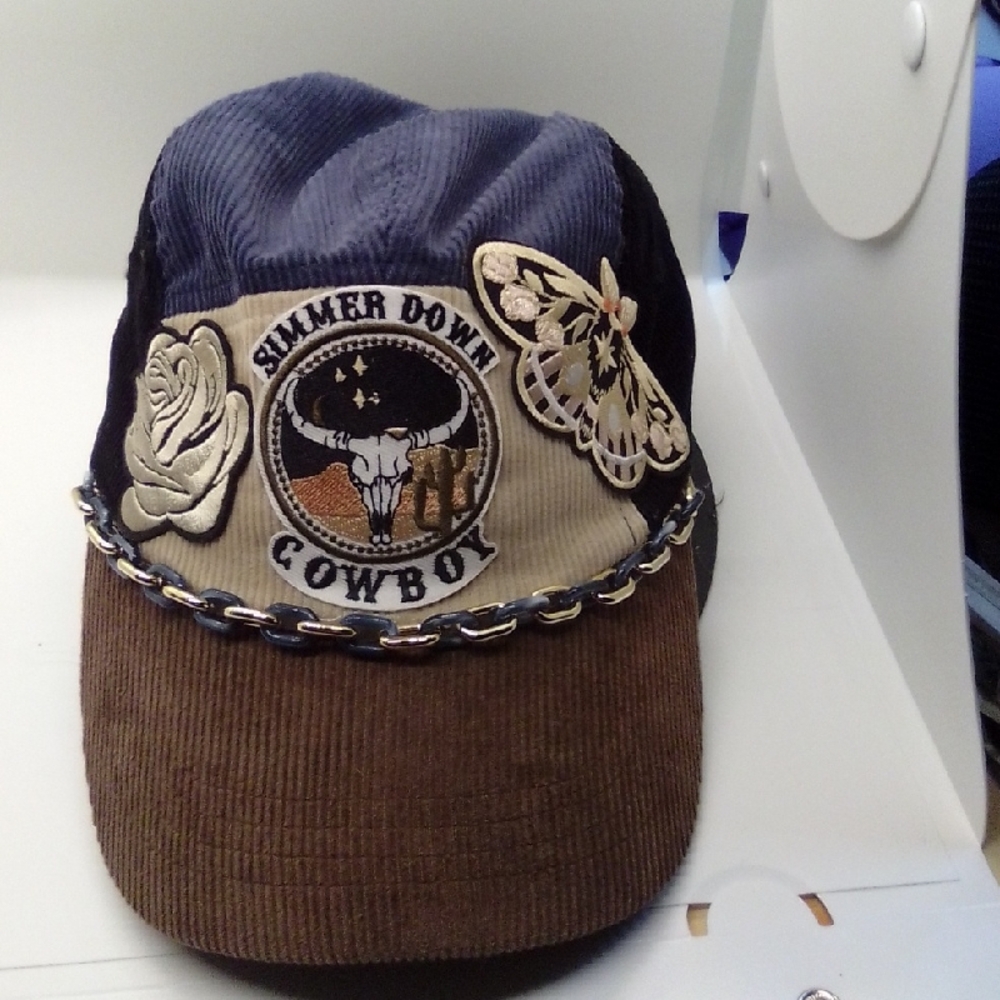 Hand Crafted Brown and Black Hat with Decorative Emblem